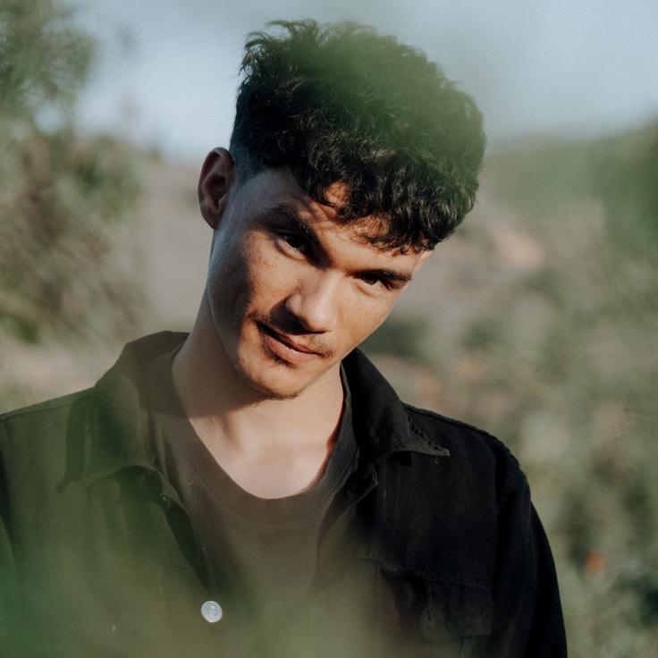 Alex Rivera, Lead Design Curator at Breeze Meadow Ridge, reviewing corporate floral arrangements